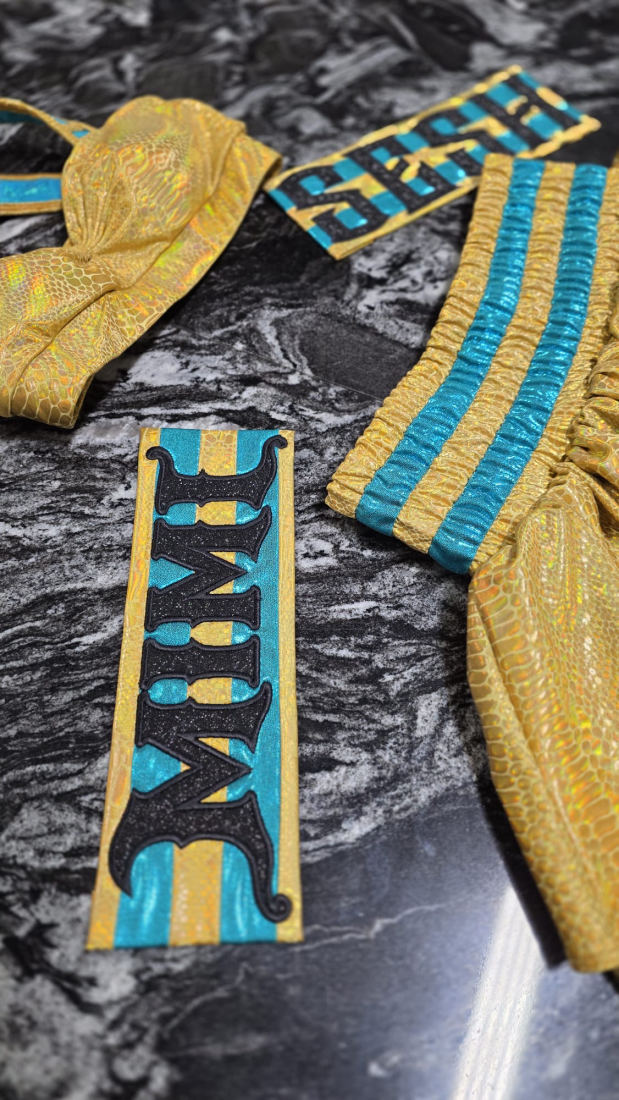 Gold and teal fabric detail with "MIMI" and "SESH" patches laid out