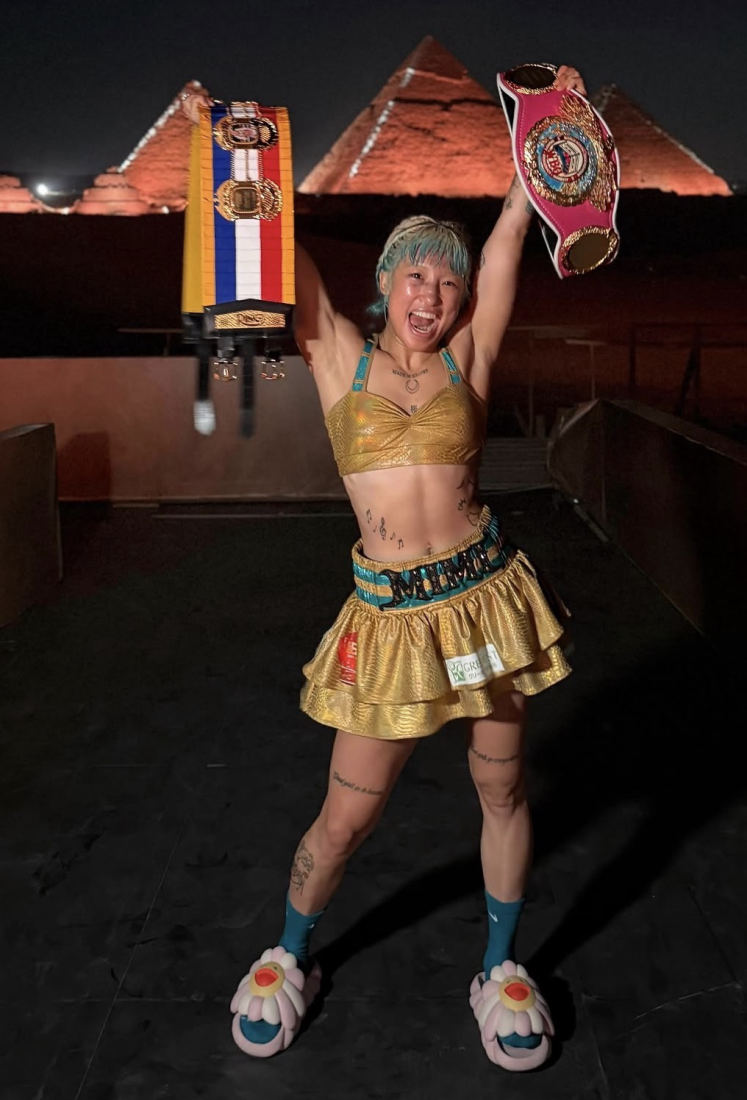 Mizuki Hiruta celebrating a title win in custom gold ring-walk gear