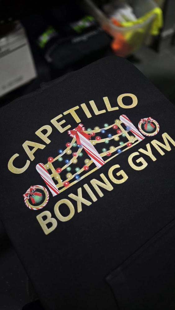 Gold foil Capetillo Boxing Gym holiday crewneck with a string-lights boxing ring graphic