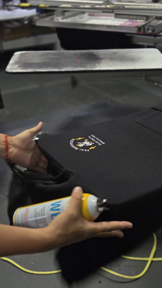 Hai Services Electrical Specialties tee being prepped on the press