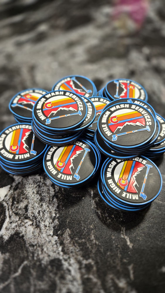 Pile of colorful Mile High Wash Services die-cut stickers