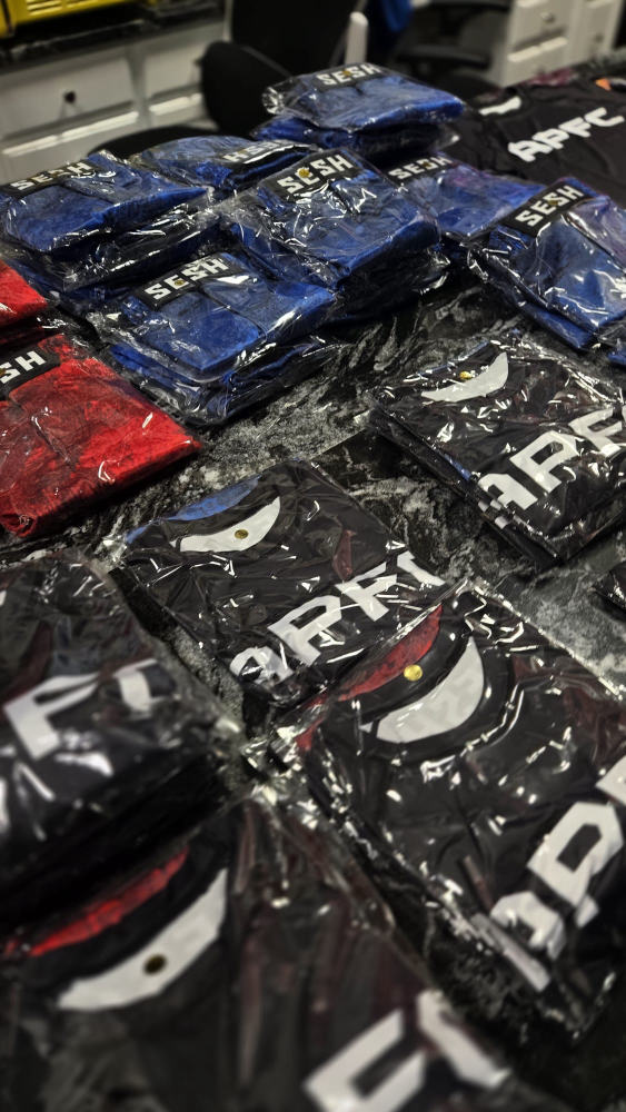 Bulk packaged SESH and APFC branded apparel ready for pickup