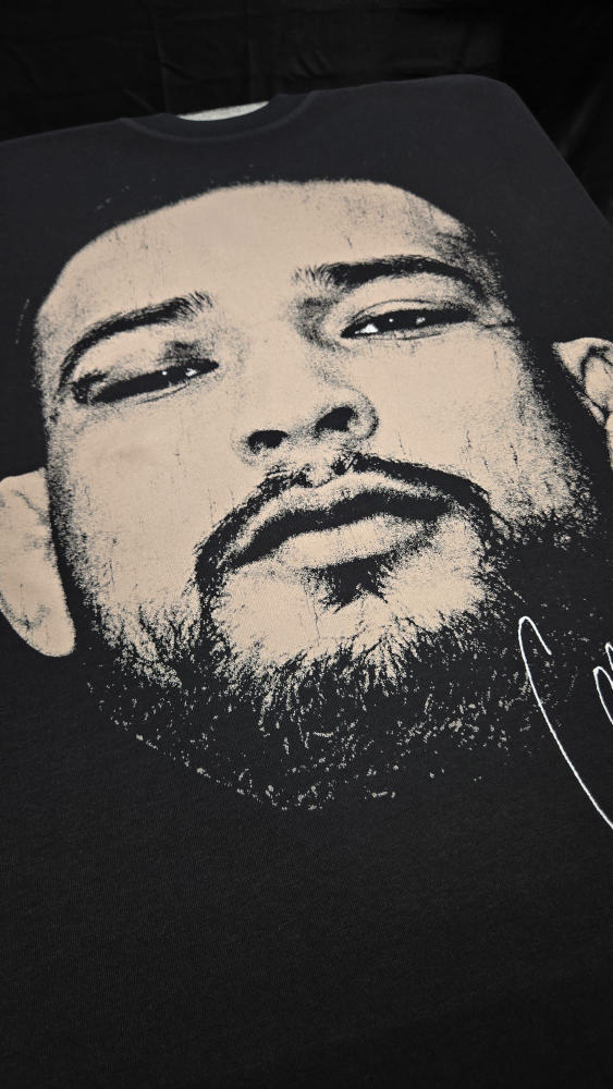 Large-scale duotone portrait print of a UFC fighter on a black tee