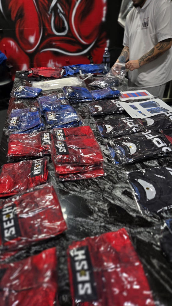 Finished SESH-branded apparel bagged and organized for a bulk order pickup