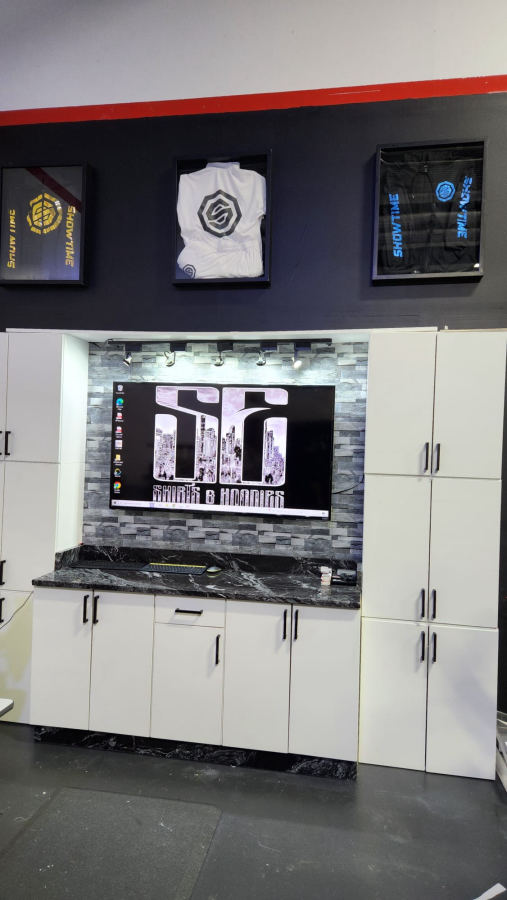 Shop display wall with framed embroidered jackets